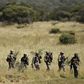 Members of the South African National Defence Force (SANDF) return after taking part in a Capability Demonstration at the Roodewal Bombing Range in Makhado, in the northern province of Limpopo, May 9, 2013. REUTERS/Siphiwe Sibeko