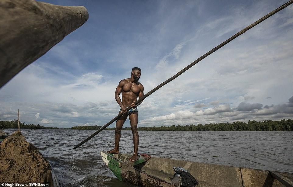 Cameroonian artisanal miners go diving in the Wouri river an average of 100 times a day for wet sand [Hugh Brown/SWNS.com]