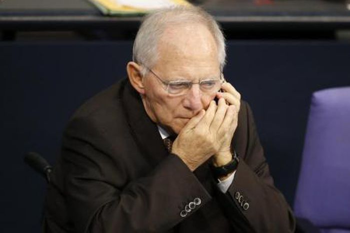 German Finance Minister Wolfgang Schaeuble uses his phone during a session of the German lower house of parliament, the Bundestag, in Berlin, Germany November 25, 2015.
