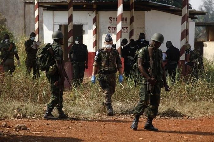 African and French peace keeping troops stand near a mass grave at a military camp in the 200 Villas neighbourhood of Bangui February 14, 2014.    REUTERS/Luc Gnago