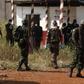 African and French peace keeping troops stand near a mass grave at a military camp in the 200 Villas neighbourhood of Bangui February 14, 2014.    REUTERS/Luc Gnago