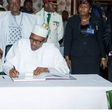 President Buhari signing the condolence register of the late Kerekou.