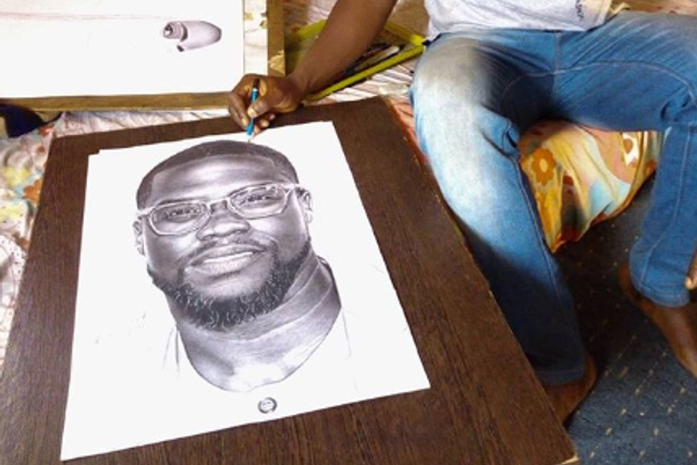 Eli Waduba with his drawing of Kevin Hart [Instagram/eliss_artss]