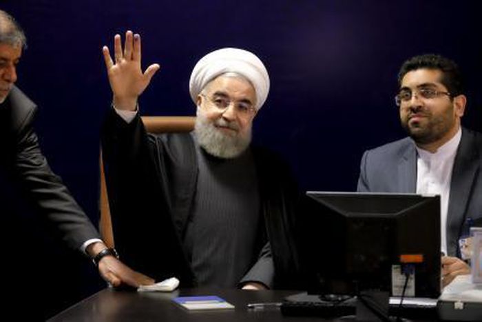 Iranian President Hassan Rouhani (C) waves after he registered for February"s election of the Assembly of Experts, the clerical body that chooses the supreme leader, at the Interior Ministry in Tehran December 21, 2015.