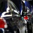 A worker walks near a row of cars at BMW's manufacturing plant in Rosslyn, outside Pretoria, September 13, 2010. REUTERS/Siphiwe Sibeko