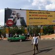 A man walks in front of an advertisement billboard of MTN phone company in Abuja, Nigeria May 25, 2015.