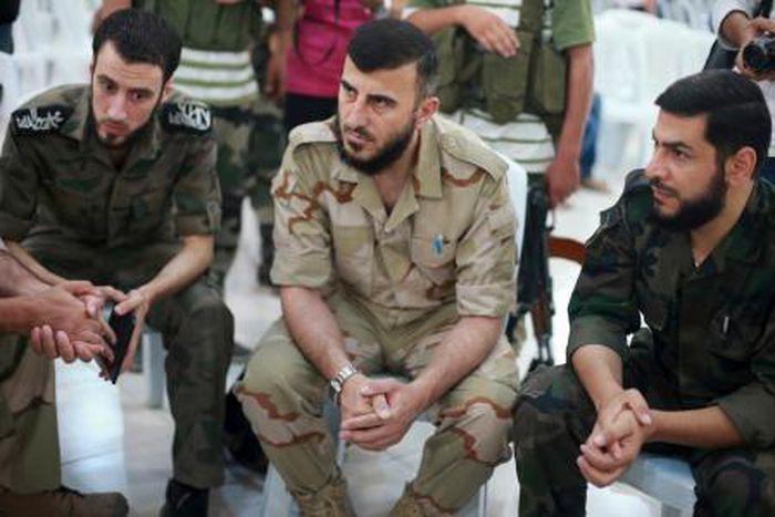 Zahran Alloush (C), commander of Jaysh al Islam, sits during a conference in the town of Douma, eastern Ghouta in Damascus, Syria August 27, 2014.