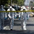 Police bomb squad personnel inspect the scene after a blast at a bus stop injured at least four people in downtown Santiago