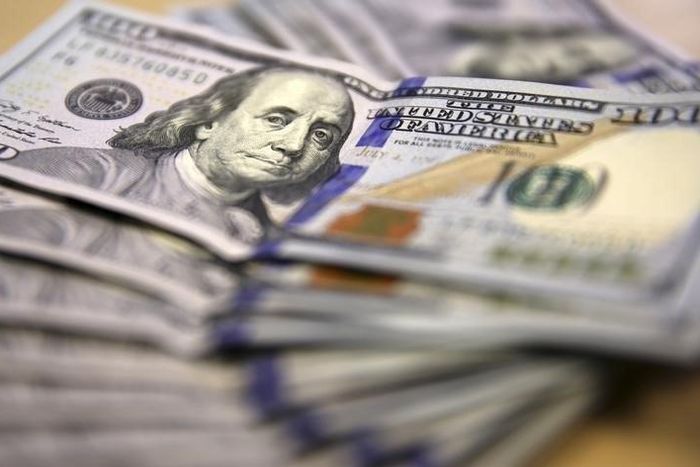 American dollar notes are displayed in this photo illustration in Johannesburg August 13, 2014. EUTERS/Siphiwe Sibeko