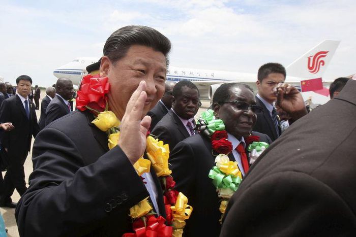 Chinese President Xi Jinping waves as he walks with Zimbabwean President Robert Mugabe (2nd L) upon arrival for a state visit in Harare, Zimbabwe December 1, 2015. REUTERS/Philimon Bulawayo
