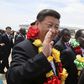 Chinese President Xi Jinping waves as he walks with Zimbabwean President Robert Mugabe (2nd L) upon arrival for a state visit in Harare, Zimbabwe December 1, 2015. REUTERS/Philimon Bulawayo