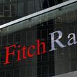 A flag is reflected on the window of the Fitch Ratings headquarters in New York February 6, 2013. REUTERS/Brendan McDermid