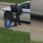 Picture of Black police officer tying boy’s shoe goes viral