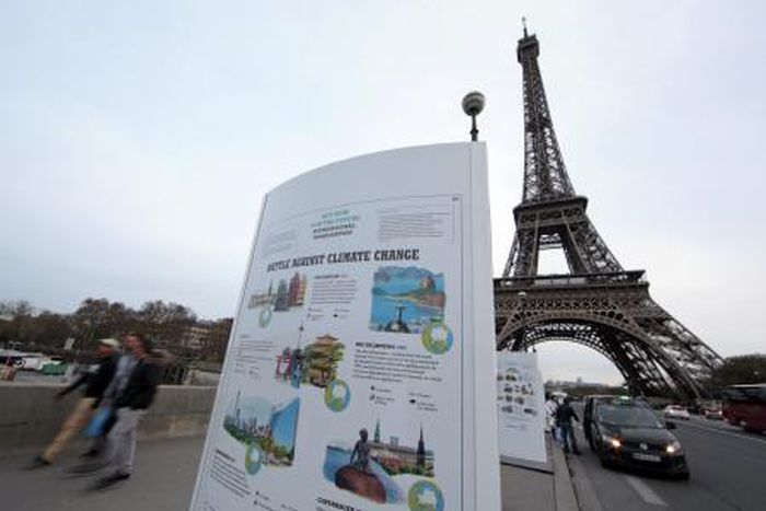 An information board about climate change is seen on a bridge near the Eiffel Tower ahead of the World Climate Conference 2015 (COP21), in Paris, France, November 28, 2015.