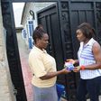 Omo Brand Ambassador, Chioma Akpotha presenting the new Omo Fast Action 100g pack to Mrs. Genevia Ikechukwu, a resident of Prof. Emeritus John Umeh, Road 28, Ngozika Estate, during the Omo Door to Door Knock held in Awka.