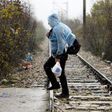 A Syrian refugee walks into Macedonia during a rainstorm after crossing the border from Greece to Macedonia near the Macedonian town of Gevgrelija November 27, 2015.