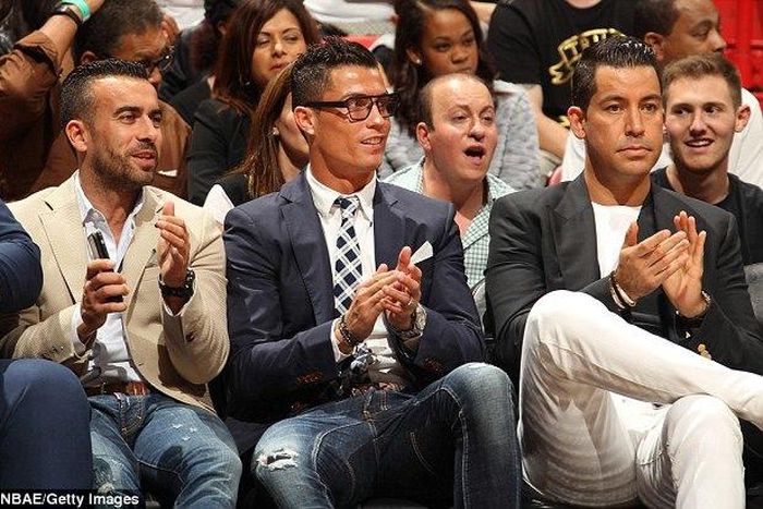 Cristiano Ronaldo and aids watching Miami Heat game against the Detroit Pistons at the American Airlines Arena.