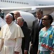 Pope Francis walks with the Central African Republic"s interim President Catherine Samba-Panza (R) after landing at the international airport of the capital Bangui, Central African Republic, November 29, 2015.