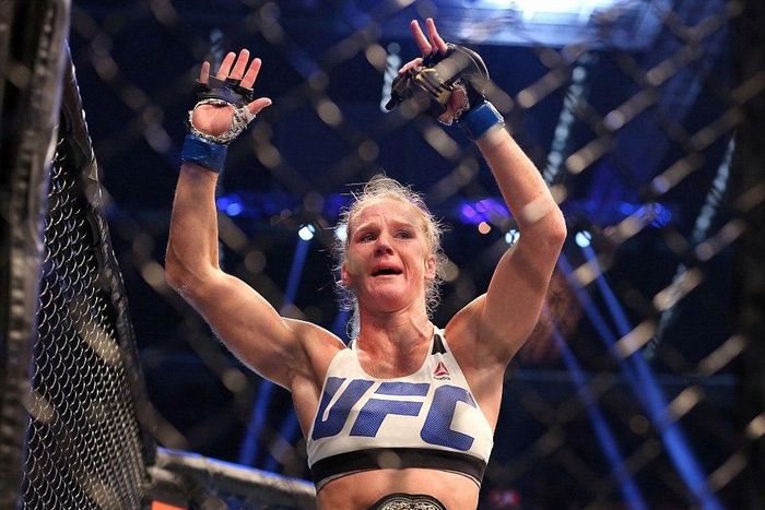 Holly Holm celebrates with her UFC belt after beating Ronda Rousey