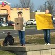 Mike Pothoff beside the panhandlers holding his sign
