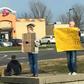 Mike Pothoff beside the panhandlers holding his sign