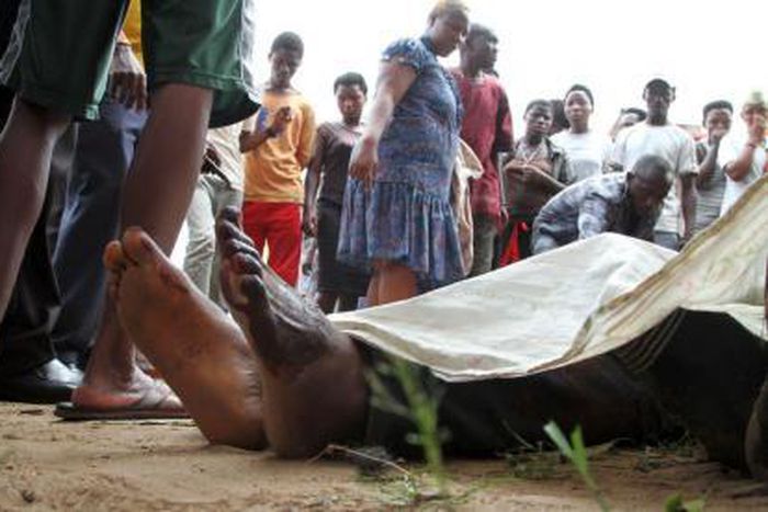 Residents look at the slain bodies of people killed at the Cibitoke district in Burundi"s capital Bujumbura, December 9, 2015.
