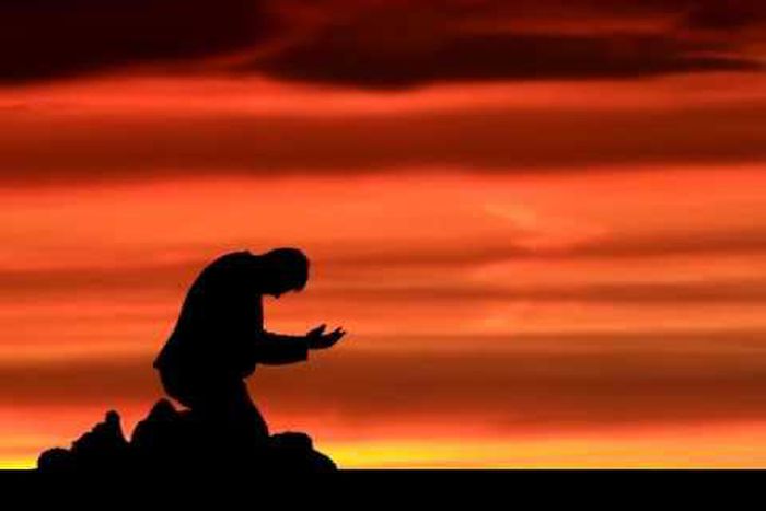 Silhouette of man on his knees