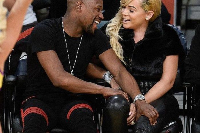 Floyd Mayweather and girlfriend Doralie Medina  watching a basket ball game