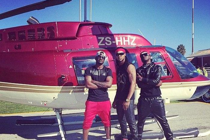 Psquare and Flavour in front of a chopper at the music video shoot