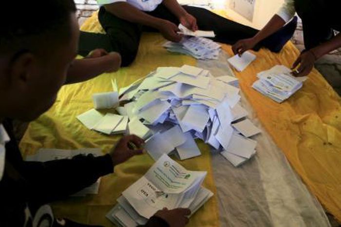 Rwanda election officials count votes as polling closes after Rwandans voted during a referendum to amend its Constitution to allow President Paul Kagame to seek a third term during next year presidential election in Rwanda"s capital Kigali, December 1...