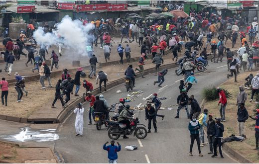 Protesters react amid clouds of tear gas fired by Kenya police officers during clashes at Saba Saba Day demonstrations in Nairobi on July 7, 2025. [SIMON MAINA/AFP via Getty Images]