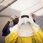 Health workers put on protective gear before entering a quarantine zone at a Red Cross facility in the town of Koidu, Kono district in Eastern Sierra Leone December 19, 2014. 
   REUTERS/Baz Ratner