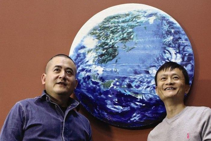 Zeng Fanzhi and Jack Ma strike a pose with their Earth painting which sold for $5.4 million at a Sotheby's auction