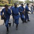A protestor (R) jeers at policemen during Presidential election day in Bujumbura's Niyakabiga district, Burundi, July 21, 2015. REUTERS/Mike Hutchings