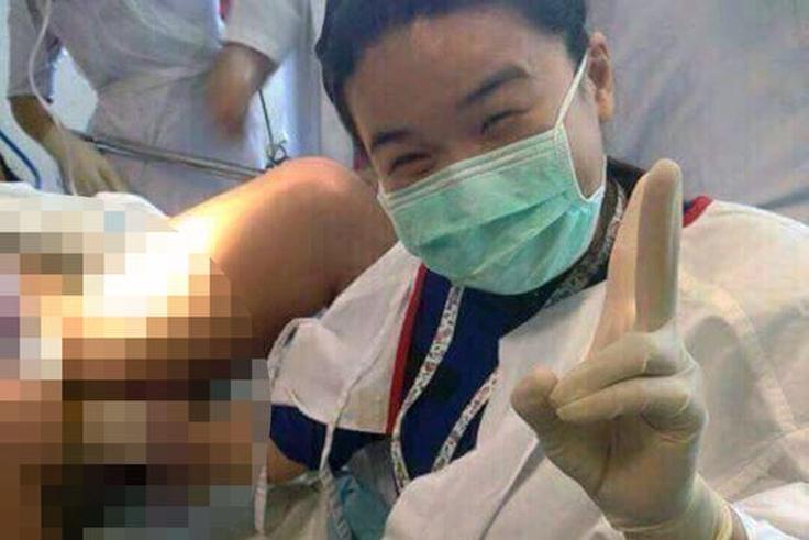 Selfie taken by doctor during surgery, with her hand inside the pregnant patients vagina