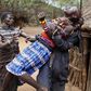 A man holds a girl as she tries to escape when she realised she is to to be married, about 80 km (50 miles) from the town of Marigat in Baringo County December 7, 2014. REUTERS/Siegfried Modola