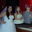 Lara Masone and her groom standing stand by side with their wedding cake made in their likeness