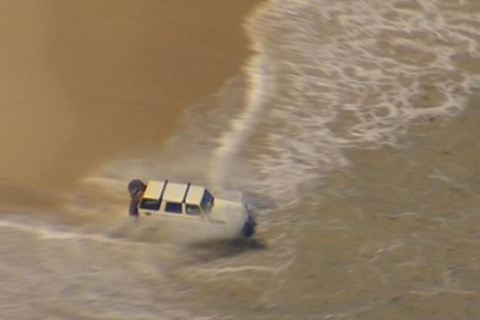 A suspected car thief made a stupid and bizarre attempt at evading police by driving his SUV straight into the sea.