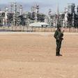 An Algerian soldier stands near the Tiguentourine Gas Plant in In Amenas, 1600 km (994 miles) southeast of Algiers, January 31, 2013. REUTERS/Louafi Larbi