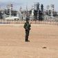 An Algerian soldier stands near the Tiguentourine Gas Plant in In Amenas, 1600 km (994 miles) southeast of Algiers, January 31, 2013. REUTERS/Louafi Larbi