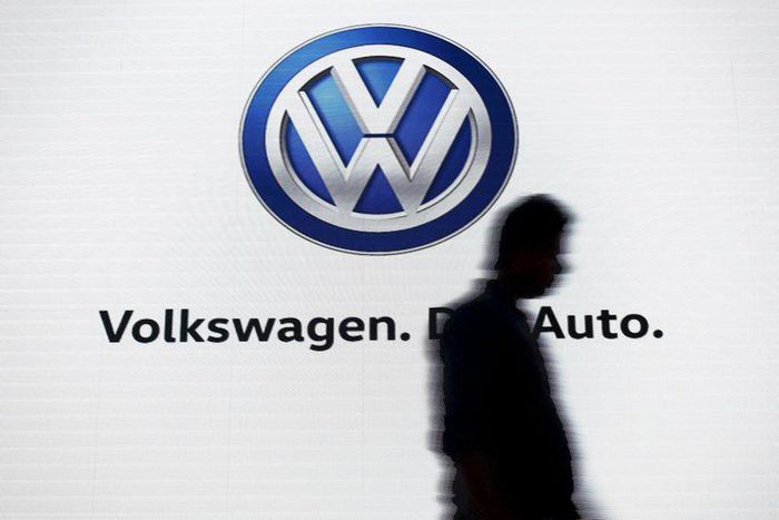A man walks past a screen displaying a Volkswagen logo in New Delhi, India, in this file photo taken June 23, 2015. REUTERS/Anindito Mukherjee/Files