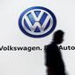 A man walks past a screen displaying a Volkswagen logo in New Delhi, India, in this file photo taken June 23, 2015. REUTERS/Anindito Mukherjee/Files