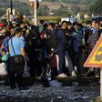 Syrian refugees gather along the train tracks as they arrive at Greece's border with Macedonia near the Greek village of Idomeni, September 11, 2015.   REUTERS/Yannis Behrakis