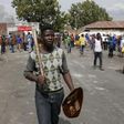 A local gestures as he holds a stick and a shield outside a hostel during anti-immigrant related violence in Johannesburg, April 17, 2015.