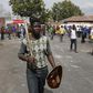 A local gestures as he holds a stick and a shield outside a hostel during anti-immigrant related violence in Johannesburg, April 17, 2015.