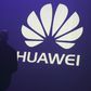 A man walks past a logo during the presentation the Huawei's new smartphone, the Ascend P7, launched by China's Huawei Technologies in Paris, May 7, 2014. REUTERS/Philippe Wojazer/Files