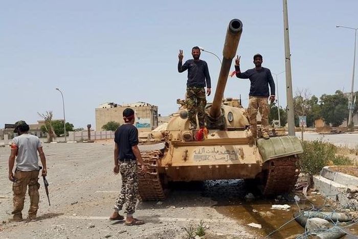 Members of the Libyan pro-government forces gesture as they stand on a tank in Benghazi, Libya, May 21, 2015. REUTERS/Stringer
