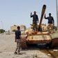 Members of the Libyan pro-government forces gesture as they stand on a tank in Benghazi, Libya, May 21, 2015. REUTERS/Stringer