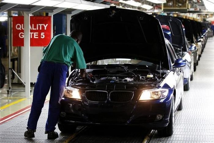 A worker inspects cars at BMW's manufacturing plant in Rosslyn, outside Pretoria, September 13, 2010. REUTERS/Siphiwe Sibeko