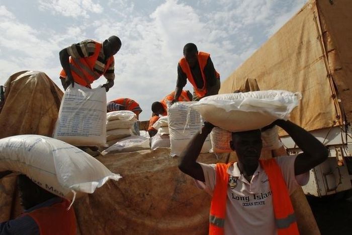 Aid workers unload food to be distributed at a camp for people displaced by the recent unrest, at the Mpoko international airport of Bangui February 12, 2014. REUTERS/Luc Gnago